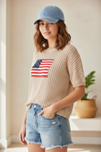 Load image into Gallery viewer, Crochet American Flag Sweater styled with denim cutoff shorts and light wash denim cap