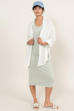 Load image into Gallery viewer, Dusty Sage Midi Dress styled with white linen top and denim cap