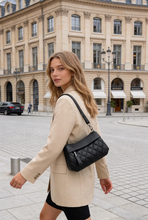 Load image into Gallery viewer, Model carrying the black On the Go Quilted Crossbody Bag