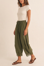 Load image into Gallery viewer, Olive lace pants in a relaxed side-angle pose
