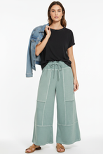 Load image into Gallery viewer, Sage green pants with black mineral wash tee and jean jacket over shoulder